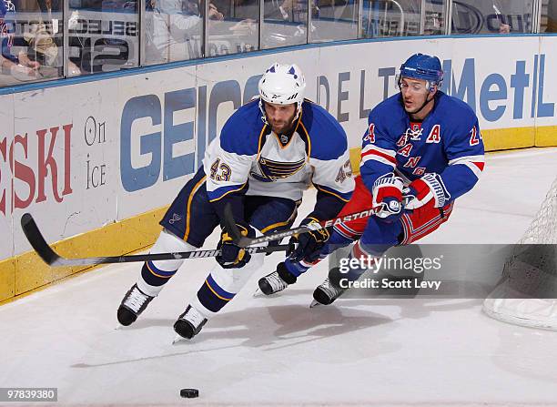 Mike Weaver of the St. Louis Blues skates for the puck under pressure by Ryan Callahan of the New York Rangers in the first period on March 18, 2010...