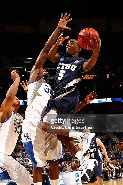 Sheldon Cooley of the East Tennessee State Buccaneers shoots the ball over Lukas Poderis of the Kentucky Wildcats during the first round of the 2010...