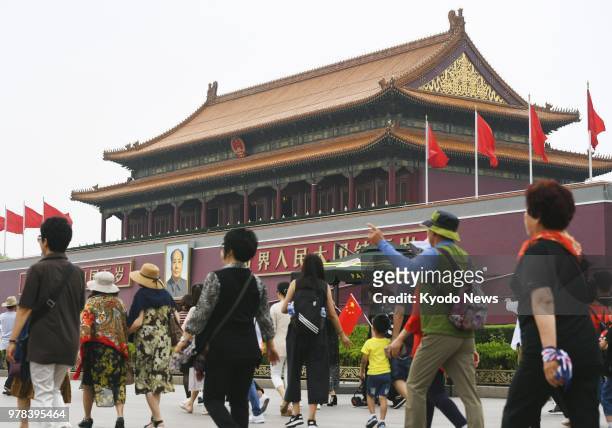 Tourists visit Tiananmen Square in Beijing on June 15, 2018. Chinese authorities made the Tiananmen Tower off-limits the same day due to renovation...