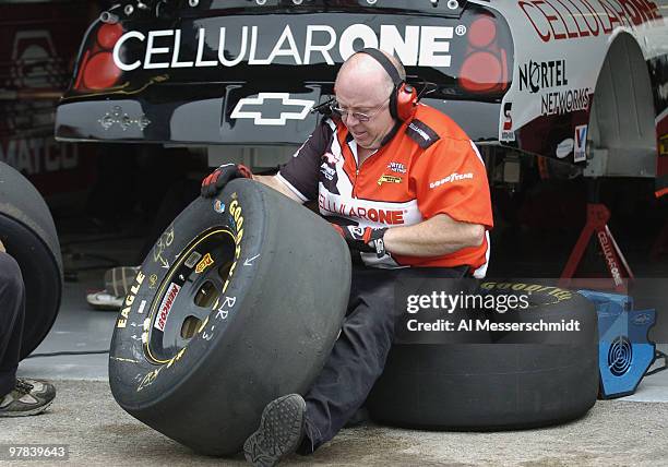 Crew worker checks the tires of Joe Nemechek's car during qualifying Friday, July 9, 2004 for the NASCAR Busch Series Tropicana Twister 300 at...