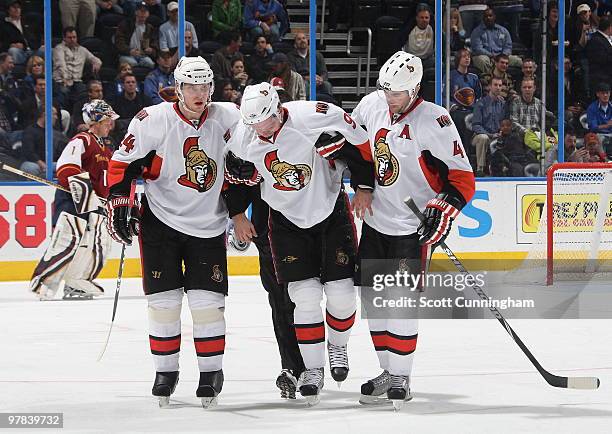 Milan Michalek of the Ottawa Senators is helped off the ice after being injured against the Atlanta Thrashers at Philips Arena on March 18, 2010 in...