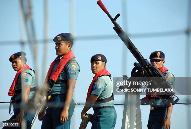 Indonesian Navy personnel stand aboard the KRI Slamet Riyadi vessel as it arrives in Denpasar near the resort island of Bali on March 18, 2010 to...