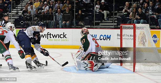Colin Wilson of the Nashville Predators scores against goalie Josh Harding of the Minnesota Wild on March 18, 2010 at the Bridgestone Arena in...