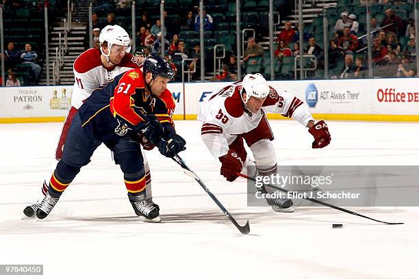 Cory Stillman of the Florida Panthers battles for the puck against Ed Jovanovski of the Phoenix Coyotes and teammate Martin Hanzal at the...