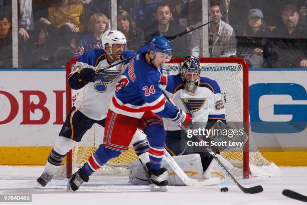 Goaltender Ty Conklin of the St. Louis Blues protects the net against Ryan Callahan of the New York Rangers in the second period on March 18, 2010 at...