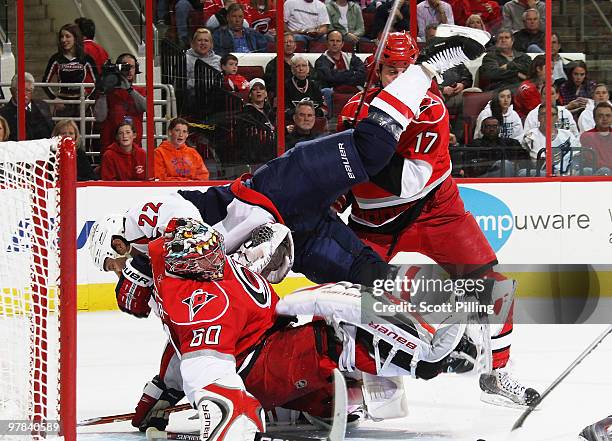 Mike Knuble of the Washington Capitals gets airborne and makes contact with Justin Peters of the Carolina Hurricanes during their NHL game on March...