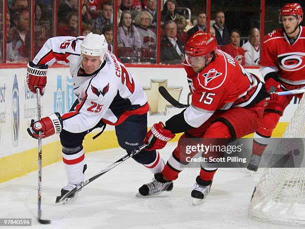 Jason Chimera of the Washington Capitals battles Tuomo Ruutu of the Carolina Hurricanes during their NHL game on March 18, 2010 at the RBC Center in...