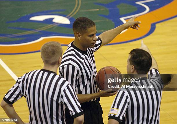 Referees huddle as Florida hosts Alabama State at the Stephen C. O'Conner Center November 28, 2005 in Gainesville, Florida. The Gators defeated the...