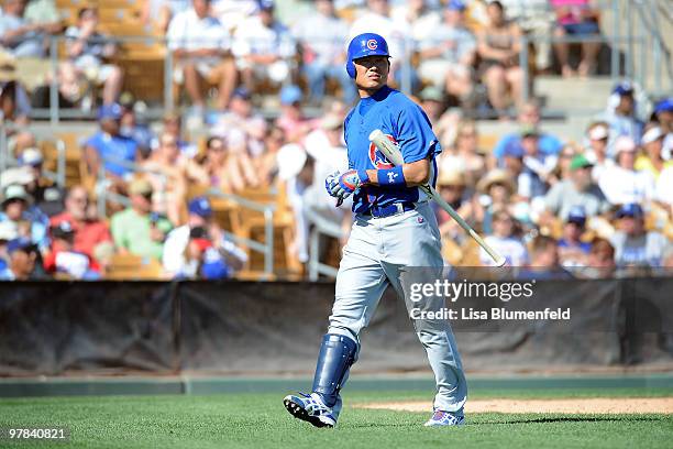 Kosuke Fukudome of the Chicago Cubs walks back to the dugout after striking out during a spring training game against the Los Angeles Dodgers on...