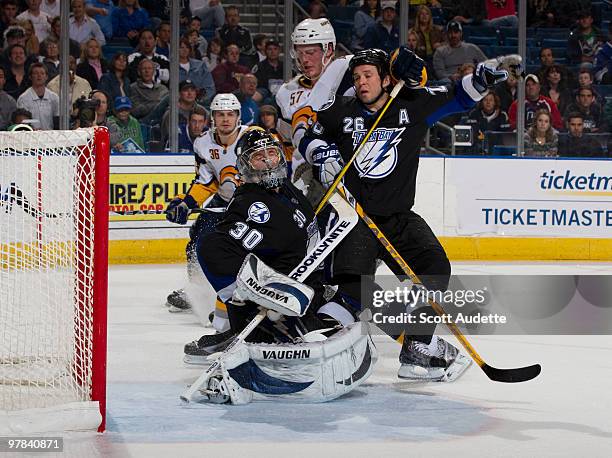 Tyler Myers of the Buffalo Sabres tries to get a shot on goal against goaltender Antero Niittymaki of the Tampa Bay Lightning as teammate Martin St....