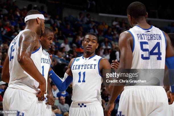 John Wall of the Kentucky Wildcats talks with his team during a timeout against the East Tennessee State Buccaneers during the first round of the...