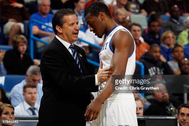 Head coach John Calipari talks with John Wall of the Kentucky Wildcats during a timeout against the East Tennessee State Buccaneers during the first...