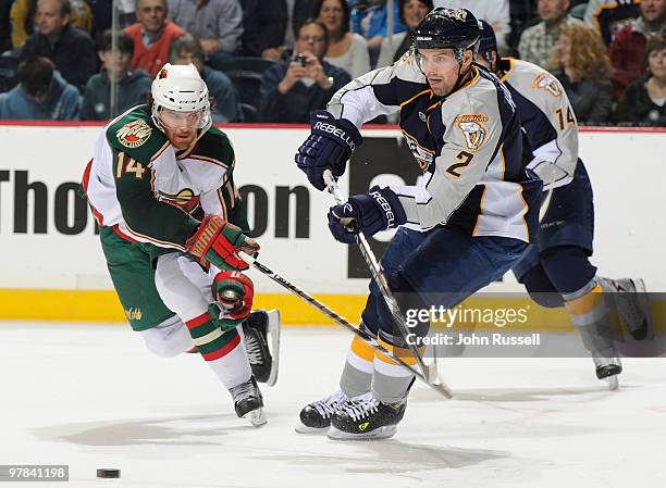 Dan Hamhuis of the Nashville Predators gets pressure from Martin Havlat of the Minnesota Wild on March 18, 2010 at the Bridgestone Arena in...