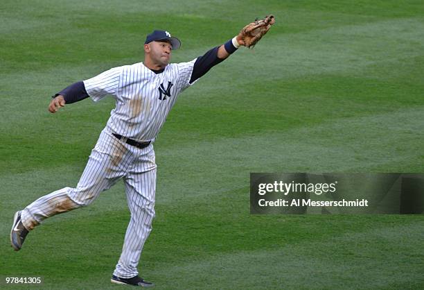 New York Yankees second baseman Miguel Cairo snags a short hit to right field against the Kansas City Royals at Yankee Stadium in Bronx, New York on...