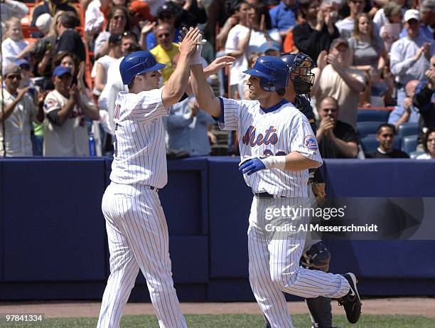 New York Mets third baseman David Wright high fives Xavier Nady after a home run against the Milwaukee Brewers at Shea Stadium in New York on April...