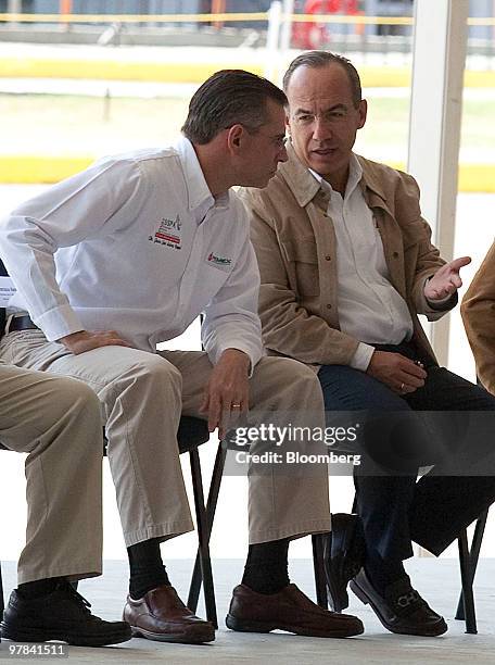 Felipe Calderon, Mexico's president, right, talks with Juan Jose Suarez Coppel, chief executive officer of Petroleos Mexicanos , during an event at...