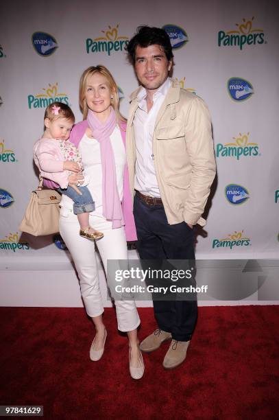 Actors Kelly Rutherford, holding daughter Helena , and Matthew Settle attend the Pampers Dry Max launch party at Helen Mills Theater on March 18,...