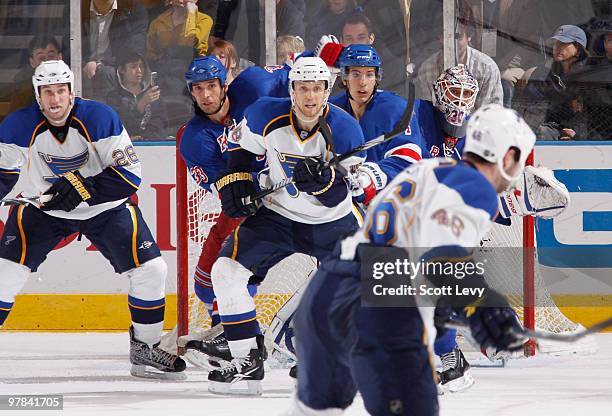 Henrik Lundqvist, Michael Del Zotto and Michal Rozsival of the New York Rangers protect the net against Roman Polak of the St. Louis Blues on March...