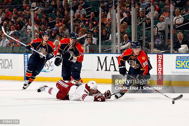 Rostislav Olesz of the Florida Panthers crosses sticks with Vernon Fiddler of the Phoenix Coyotes at the BankAtlantic Center on March 18, 2010 in...