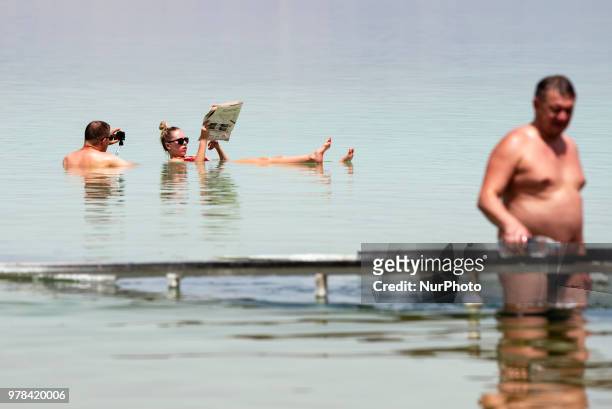 Tourist reads a newspaper while floating in the Dead Sea in Israel on June 17, 2018. The Dead Sea is a popular travel destination and lies 422 meters...