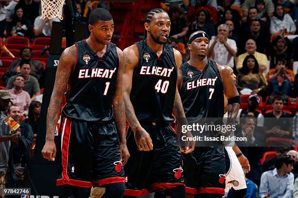 Dorell Wright, Udonis Haslem and Jermaine O'Neal of the Miami Heat take a breather against the Orlando Magic on March 18, 2010 at American Airlines...