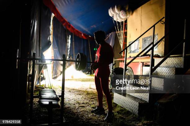 Acrobat Armando Leon of Cuba trains with weights backstage at Zippo's circus in Victoria Park on June 15, 2018 in Glasgow, Scotland. As the British...