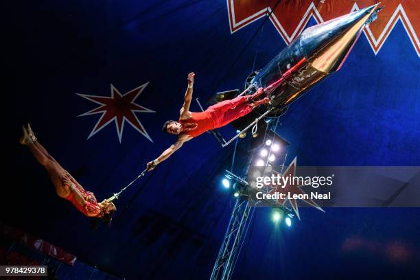 Pablo Garcia of Ireland supports his wife Vicky Fossett Garcia of Ireland as she spins beneath a rocket above the ring during a performance at...