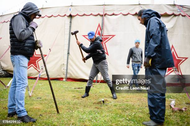 Ionut Muresan from Romania secures another tent stake during high winds at Zippo's circus in Victoria Park on June 14, 2018 in Glasgow, Scotland. As...