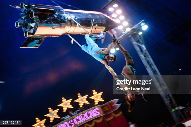 Pablo Garcia of Ireland holds his wife Vicky Fossett Garcia beneath a rocket as it revolves above the ring during a performance at Zippo's circus in...