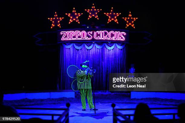 Clown Totti Alexis performs in a UV suit during a performance at Zippo's circus in Victoria Park on June 13, 2018 in Glasgow, Scotland. As the...