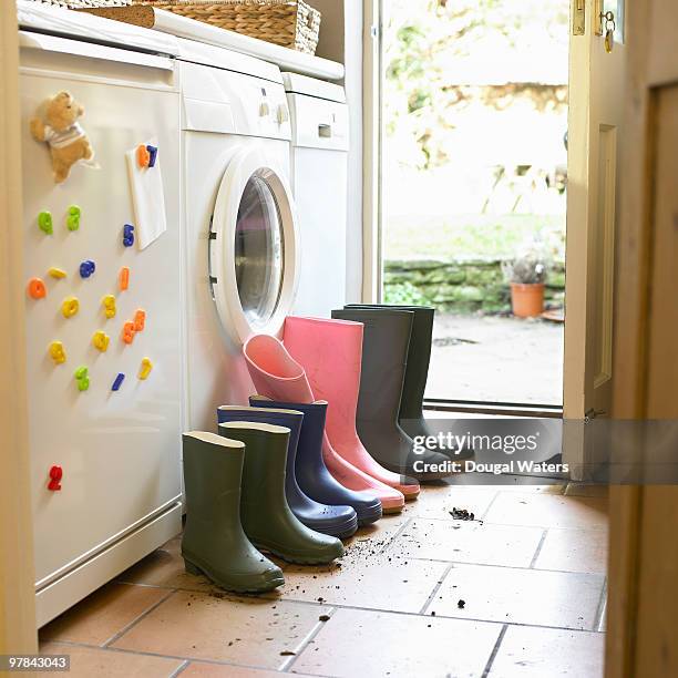 wellington boots lined up in utility room. - sapatos sujos dentro de casa imagens e fotografias de stock