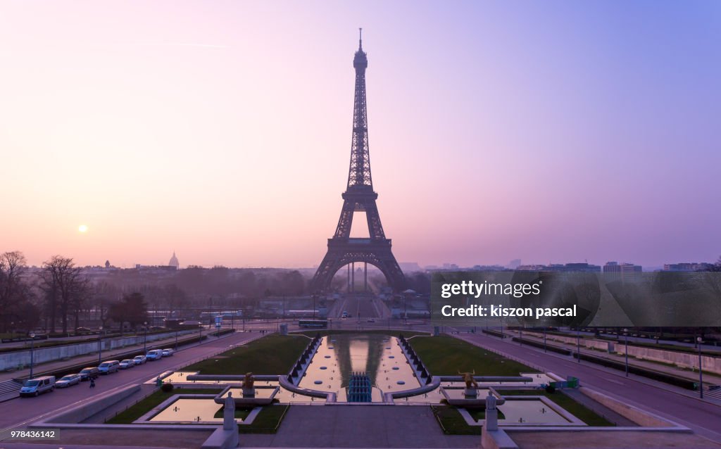 The famous Eiffel tower in Paris during a colorful sunrise , France