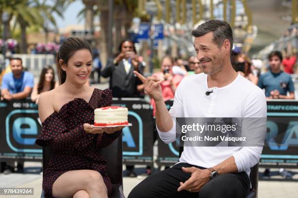 Rachel Bilson presents Eddie Cibrian a birthday cake at 'Extra' at Universal Studios Hollywood on June 18, 2018 in Universal City, California.