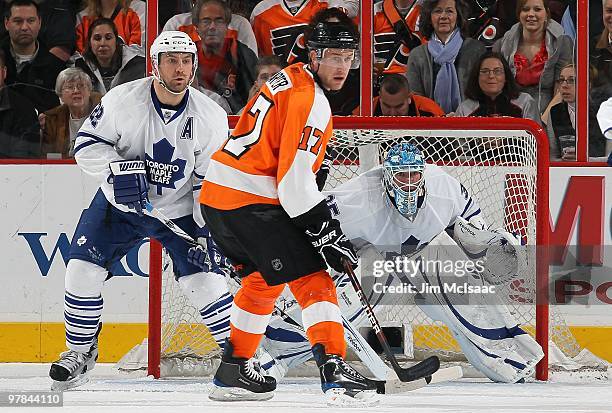 Jean-Sebastien Giguere and Francois Beauchemin of the Toronto Maple Leafs defend against Jeff Carter of the Philadelphia Flyers on March 7, 2010 at...
