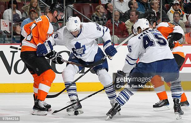 Christian Hanson and Viktor Stalberg of the Toronto Maple Leafs skate against Jeff Carter of the Philadelphia Flyers on March 7, 2010 at Wachovia...