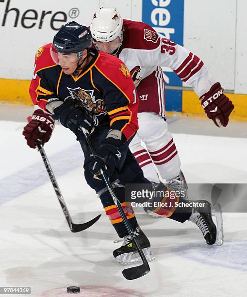 David Booth of the Florida Panthers skates with the puck against Vernon Fiddler of the Phoenix Coyotes at the BankAtlantic Center on March 18, 2010...