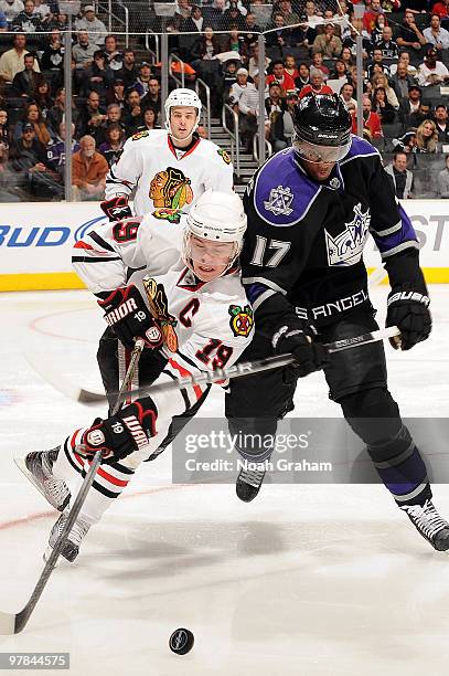 Jonathan Toews of the Chicago Blackhawks battle for the puck against Wayne Simmonds of the Los Angeles Kings during the game on March 18, 2010 at...