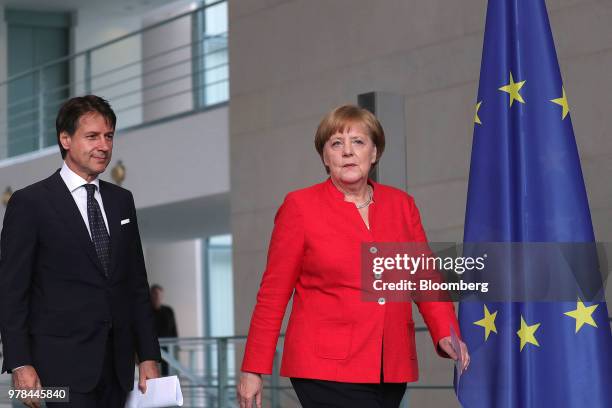 Giuseppe Conte, Italy's prime minister, left, and Angela Merkel, Germany's chancellor, walk to a press conference at the Chancellery building in...