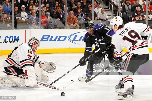 Antti Niemi and Jonathan Toews of the Chicago Blackhawks of the stop the puck against Wayne Simmonds of the Los Angeles Kings during the game on...