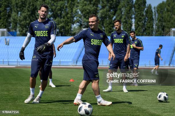 Switzerland's goalkeeper Roman Buerki, forward Xherdan Shaqiri, forward Haris Seferovic and midfielder Blerim Dzemaili take part in a training...