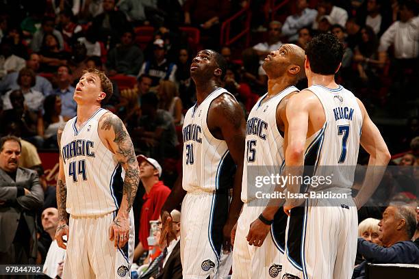 Jason Williams, Brandon Bass, Vince Carter and J.J. Redick of the Orlando Magic take a breather on March 18, 2010 at American Airlines Arena in...