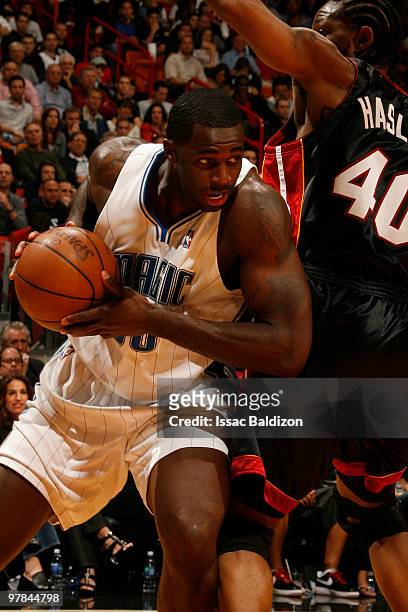 Brandon Bass of the Orlando Magic drives against Udonis Haslem of the Miami Heat on March 18, 2010 at American Airlines Arena in Miami, Florida. NOTE...
