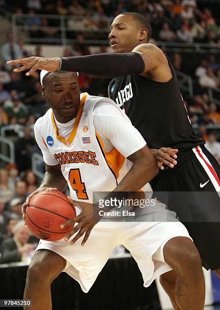 Wayne Chism of the Tennessee Volunteers is pressured by Billy White of the San Diego State Aztecs during the first round of the 2010 NCAA men's...