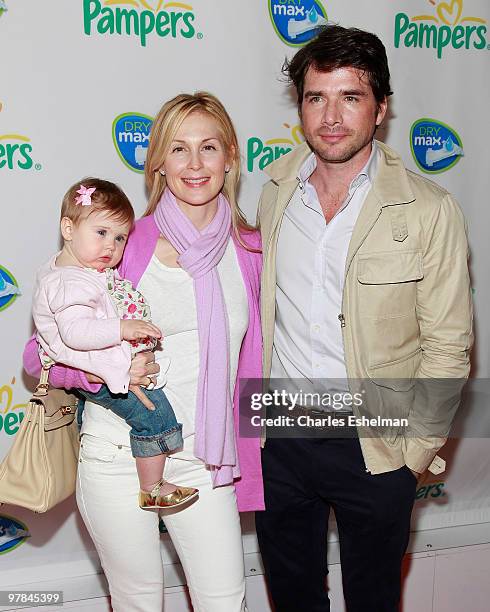 Actors Kelly Ruthterford holding daughter Helena and Matthew Settle attend the Pampers Dry Max launch party at Helen Mills Theater on March 18, 2010...