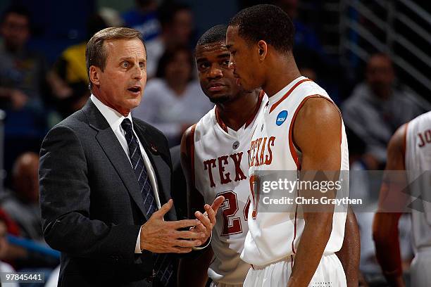 Head coach Rick Barnes talks with Justin Mason and Avery Bradley of the Texas Longhorns during a timeout against the Wake Forest Demon Deacons during...