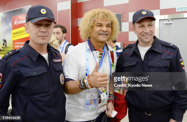 Colombian former football player Carlos Valderrama poses for a photo with police officers at Saransk airport in the Russian city on June 18 a day...