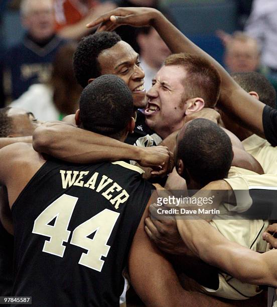 Members of the Wake Forest Demon Deacons lift Ishmael Smith, top left, into the air after he hit a last second shot in overtime to beat the Texas...