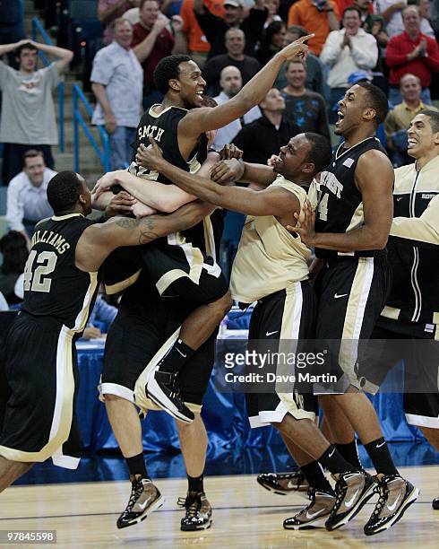 Members of the Wake Forest Demon Deacons lift Ishmael Smith into the air after he hit a last second shot in overtime to beat the Texas Longhorns...