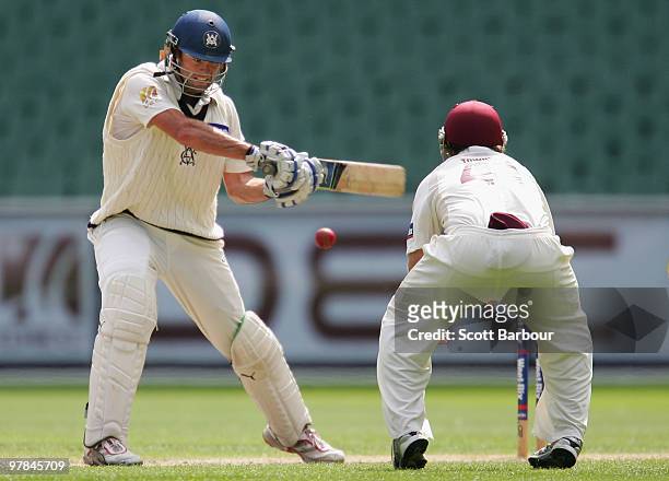 Rob Quiney of the Bushrangers cuts the ball during day three of the Sheffield Shield Final between the Victorian Bushrangers and the Queensland Bulls...