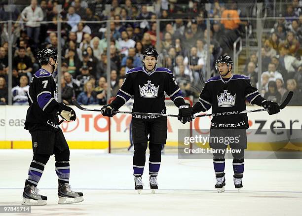 Alexander Frolov, Brad Richardson and Rob Scuderi of the Los Angeles Kings react after a goal by the Chicago Blackhawks to take a 1-0 lead during the...